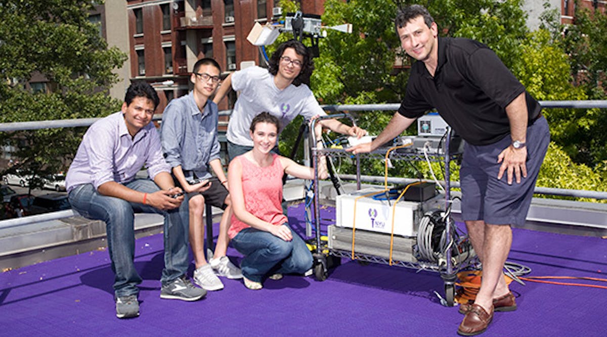 Theodore Rappaport (right) and members of NYU WIRELESS showcase some of their research. (Image courtesy of NYU)