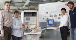 Standing in front of a large poster of 60GHz radio fundamentals this design and development team is creating ISM applications for highspeed data and video streaming at millimeterwave frequencies Photo courtesy of IHP Microelectronics Standing in front of a large poster of 60GHz radio fundamentals this design and development team is creating ISM applications for highspeed data and video streaming at millimeterwave frequencies Photo courtesy of IHP Microelectronics