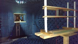 2. The researchers tested their metamaterial-based antenna in an anechoic chamber. The radio wave is sent out from the horn antenna on the left and received by the metasurface antenna mounted on the wood frame on the right (identified by a red dashed-line box). The anechoic chamber not only eliminates background signals from other sources, but it also prevents stray signals from the radio-wave source from bouncing around the room and affecting measurements. 2. The researchers tested their metamaterial-based antenna in an anechoic chamber. The radio wave is sent out from the horn antenna on the left and received by the metasurface antenna mounted on the wood frame on the right (identified by a red dashed-line box). The anechoic chamber not only eliminates background signals from other sources, but it also prevents stray signals from the radio-wave source from bouncing around the room and affecting measurements.