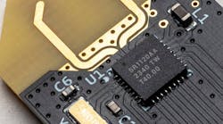 A Spark Microsystems SR1120 UWB transceiver chip is mounted on a printed-circuit board A Spark Microsystems SR1120 UWB transceiver chip is mounted on a printed-circuit board